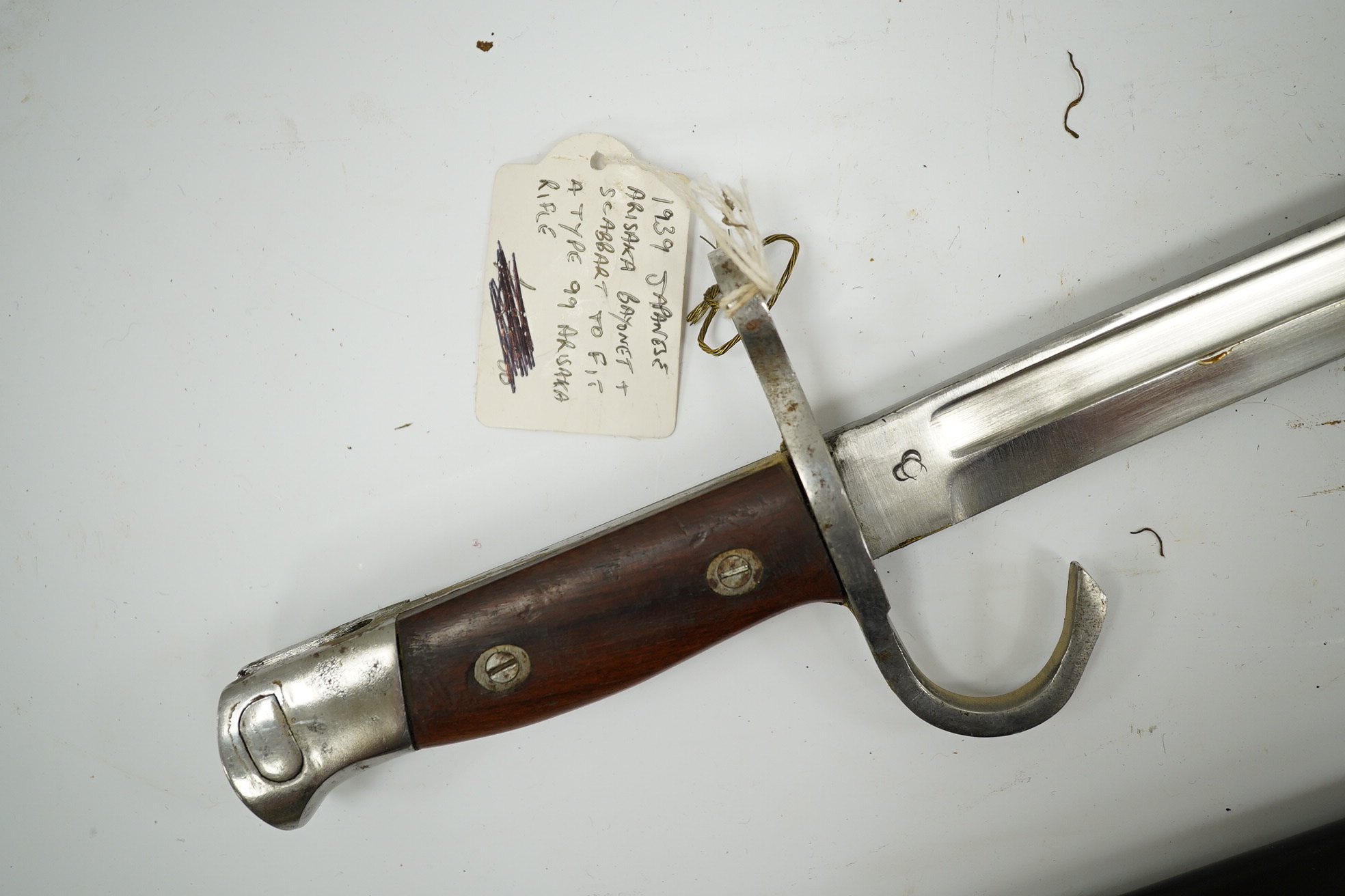 Three bayonets; a Japanese Arisaka bayonet, cleaned bright in its metal scabbard, a Nagant bayonet with quatrefoil blade, in good condition but missing scabbard, and a French Gras bayonet with the blade cut down. Conditi